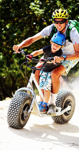 dad and son riding a Scootours