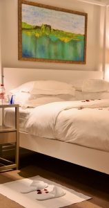 Le Franschhoek Hotel & Spa bedroom with red rose petals