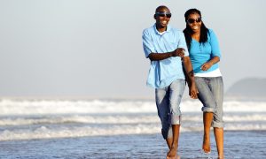 couple walking along the ocean