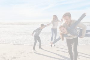 family playing on the beach