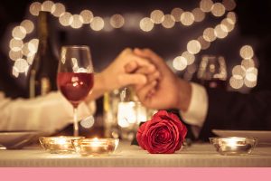 couple holding hands at romantic dinner